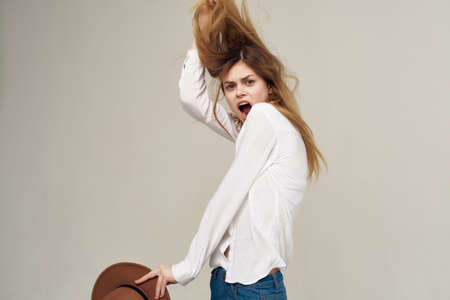 woman in white shirt fashionable hairstyle bright makeup studioの写真素材
