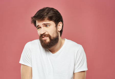 emotional man in a white t-shirt irritated facial expression Studioの写真素材