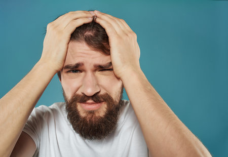 Man in a white t-shirt irritated facial expression Studioの写真素材