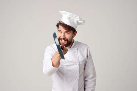 a man in a chefs uniform pan cooking kitchen isolated backgroundの写真素材