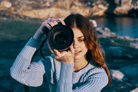 red-haired woman photographer nature rocky mountains professionalの写真素材