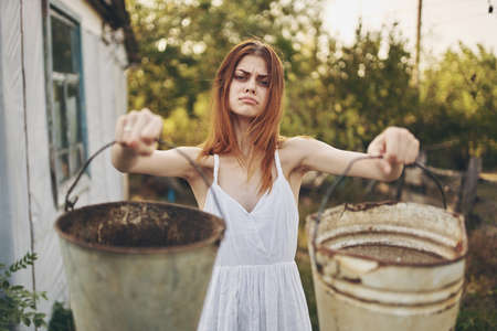 pretty woman with buckets in hand Sun freedomの写真素材