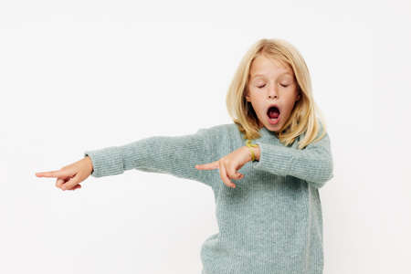 Portrait of a smiling little cutie with blond hair on a light backgroundの写真素材
