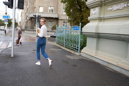 student with a book in his hands outdoors reading communication