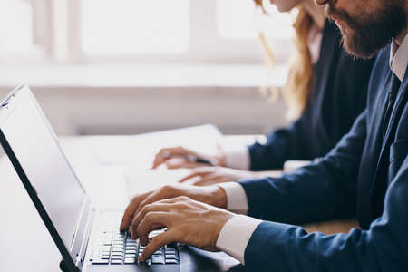 managers sitting at a desk with a laptop communication finance officialsの写真素材