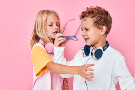 funny little boy and girl blonde hair fashionable glasses casual kids fashionの写真素材