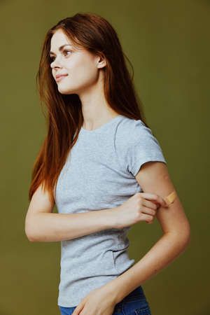 pretty woman with adhesive plaster on her armの写真素材