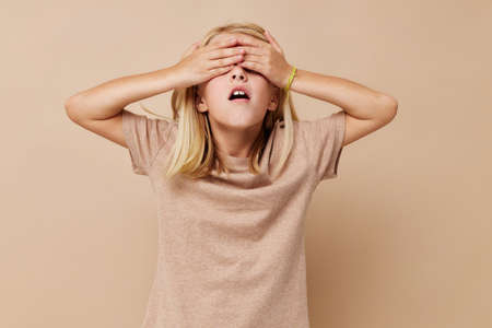 Portrait of a smiling little cutie in a beige t-shirt lifestyle conceptの写真素材