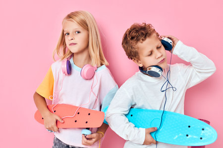 funny kids with headphones skateboards music fashion pink backgroundの写真素材