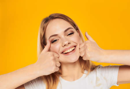 pretty woman in a white t-shirt hand gesture isolated backgroundの写真素材