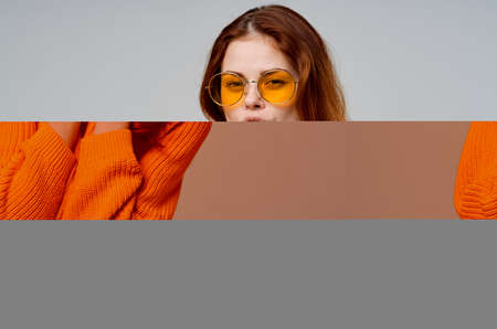 red-haired woman in yellow glasses posing fun lifestyle light background