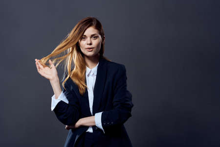 woman in business suit executive office dark backgroundの写真素材