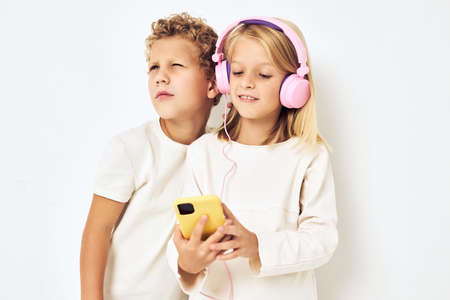 Portrait of girl and boy listening to music in headphones lifestyle childhood