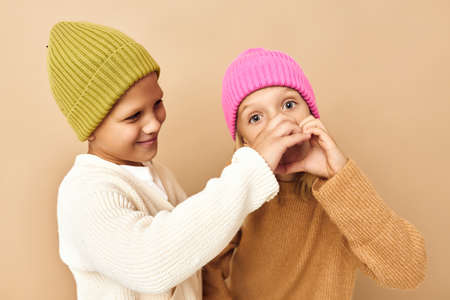 boy and girl friendship hug childhood grimace emotions beige background