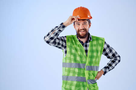 emotional man in working uniform construction building profession blue backgroundの写真素材