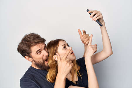 cheerful young couple hug communication friendship posing light background