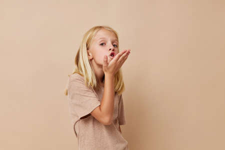 Positive little girl with blond hair isolated background