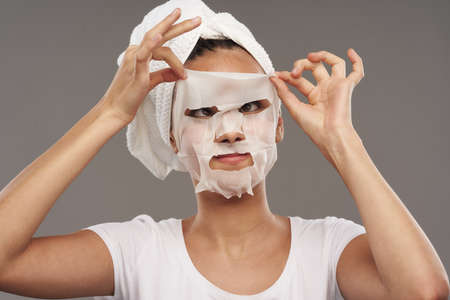 woman white t-shirt face mask skin care dermatologyの写真素材
