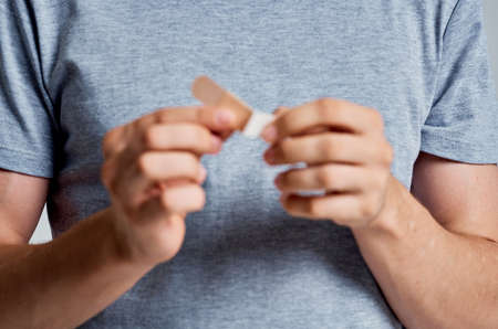 man holding plaster in hands treatment help