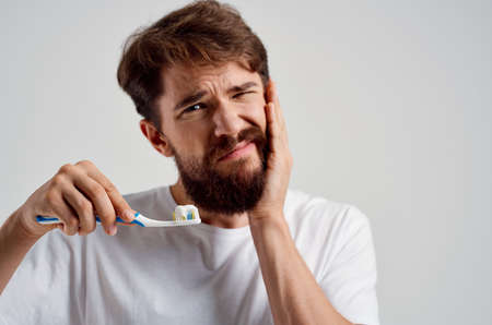 man dental care dentistry toothache light backgroundの写真素材
