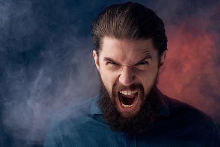 portrait of a man in a black shirt smoke clouds close-upの写真素材