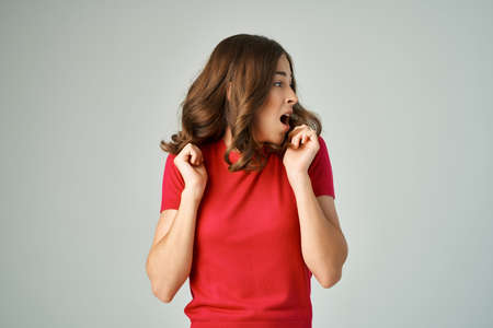 beautiful woman in a white t-shirt hair care light backgroundの写真素材