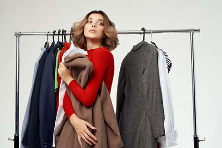 cheerful woman trying on clothes shop shopaholic isolated backgroundの写真素材