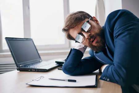 businessmen sitting at a desk in front of a laptop finance network officialの写真素材