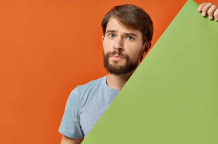 bearded man advertising marketing copy space orange backgroundの写真素材