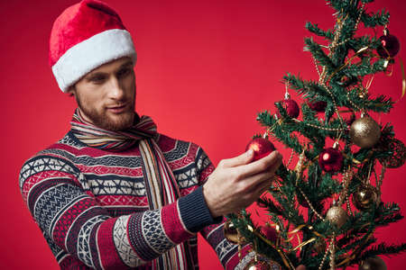 Cheerful man in a santa hat Christmas decorations holiday New Year studio posingの写真素材