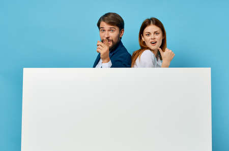 funny man and woman advertising presentation white banner copy-space studioの写真素材