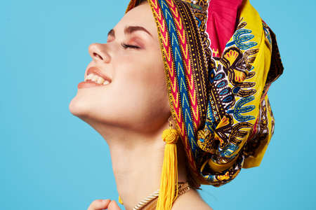 pretty woman in multicolored turban attractive look Jewelry smile Studio Modelの写真素材