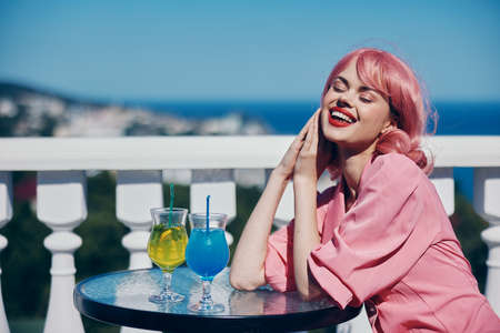 Young female drinking a cocktail on the terrace Happy female relaxingの写真素材