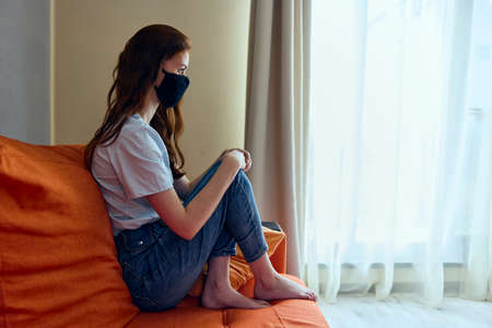 portrait of a woman home quarantined pandemic face shield stay home conceptの写真素材