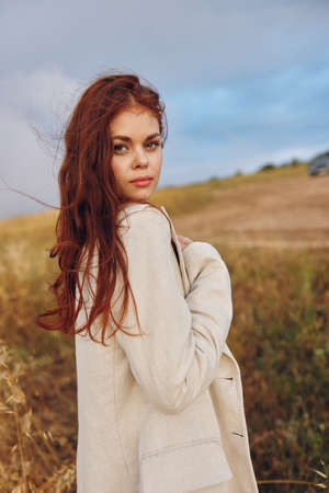 woman walk in the field sunny dayの写真素材