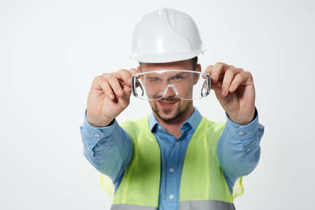 male builder in working form construction work light background
