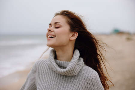 portrait of a woman alone by the ocean cloudy weather Relaxation concept