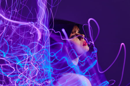 Portrait of a charming lady neon lines posing model glamor color background unalteredの写真素材