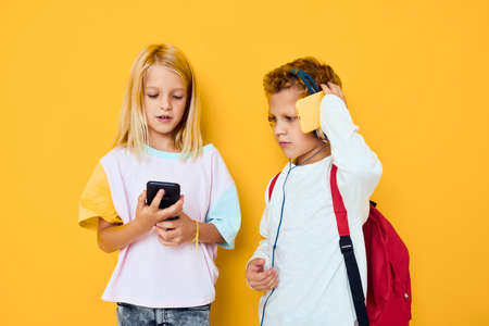 Portrait of his he her she looking at the phone entertainment communication Studio education conceptの写真素材