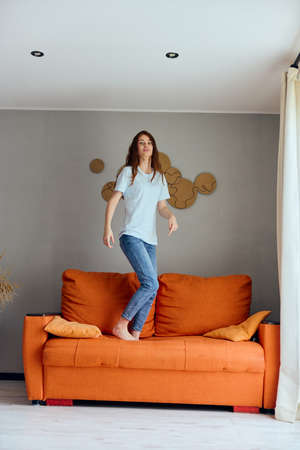 woman relaxing at home in the room on the couch interior apartmentsの写真素材