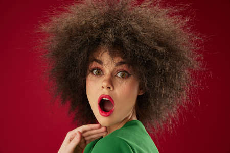 Beauty Fashion woman Afro hairstyle green dress emotions close-up color background unalteredの写真素材