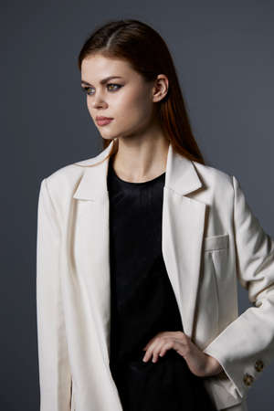 young woman posing long hair makeup luxury gray backgroundの写真素材