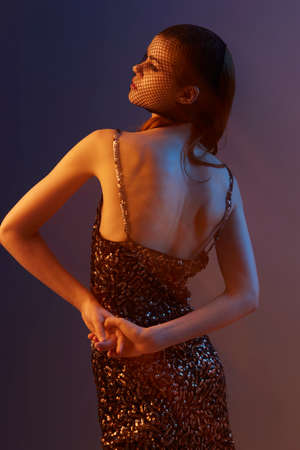 attractive woman in a shiny dress posing luxury isolated background