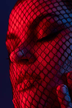 young woman black veil posing eye-catching glamor color backgroundの写真素材
