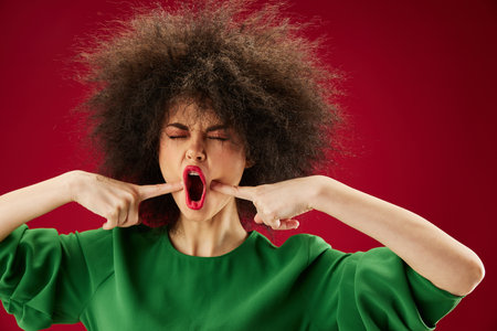 Beauty Fashion woman with curly hair grimace posing emotion color background unalteredの写真素材