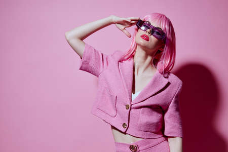 Young positive woman bright makeup pink hair glamor stylish glasses Studio Model unaltered