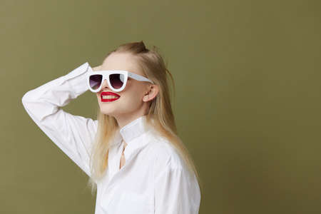 glamorous woman in white shirt sunglasses isolated backgroundの写真素材