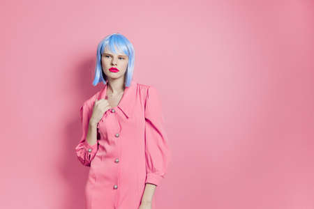 glamorous woman in blue wig pink dress red lips Lifestyle posingの写真素材