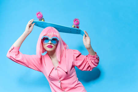 fashionable woman fashion blue glasses skateboard isolated background