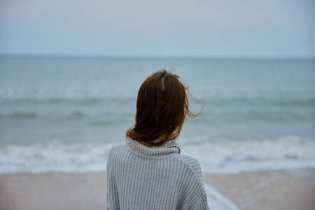woman with long hair on the beach nature landscape walk Happy female relaxingの写真素材